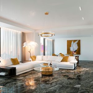 A imagem mostra o Pendente led BLOE 82CM da Nordecor, cujo design amplo e circular com acabamento dourado brilha como ponto central na sala de estar. A peça emana uma luz quente e acolhedora, refletindo-se no piso polido e complementando a decoração luxuosa do ambiente com sua presença moderna e sofisticada.