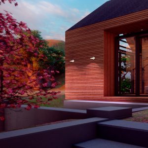 A imagem captura o encanto da Arandela Led PYANA em um cenário ao entardecer, onde duas peças estão instaladas em uma parede de madeira, complementando a arquitetura moderna de uma construção com grandes janelas de vidro. As arandelas emitem uma luz suave que realça a textura natural da madeira, criando um efeito visual atraente e acolhedor que convida à entrada da residência. A luminosidade delas oferece um contraste caloroso ao crepúsculo, aumentando a segurança e a visibilidade, enquanto se integra harmoniosamente com o ambiente externo. As plantas e as árvores ao redor adicionam uma sensação de tranquilidade e beleza natural ao local.