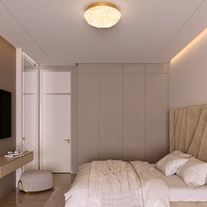 Contemporary bedroom with a large beige upholstered headboard, neatly made bed, and built-in gray wardrobe along the wall.