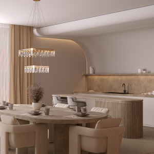 Round dining table set for a meal in a beige-toned open kitchen with a crystal chandelier and soft curtains in the background.