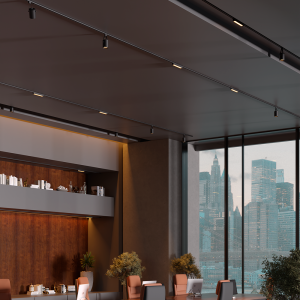 Modern office space with large glass windows overlooking a city skyline, wood paneling, and a long desk with laptops and chairs behind it on a warm-toned set.